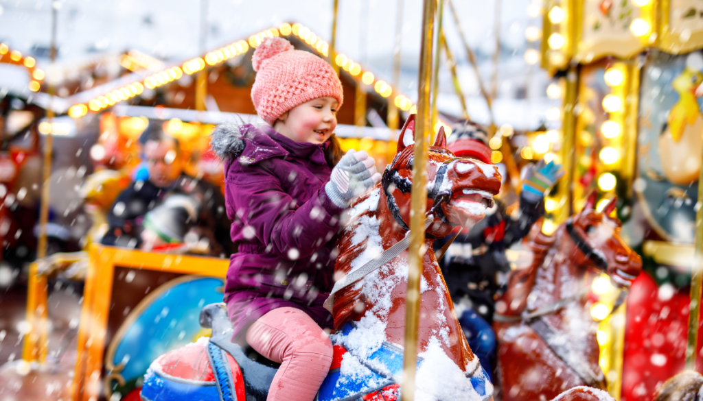 Child enjoying the funfair at an insured winter wonderland.