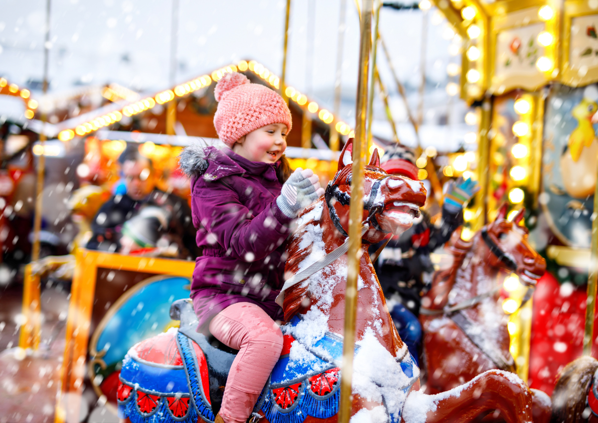 Child enjoying the funfair at an insured winter wonderland.