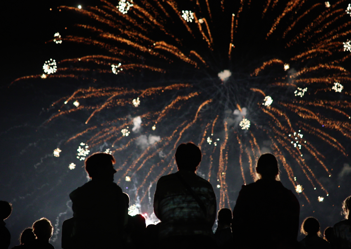 Group of people watching an insured firework display.
