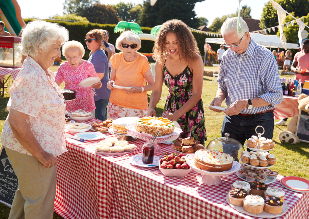 Treats and food being handed out to the public at a Spring fete.