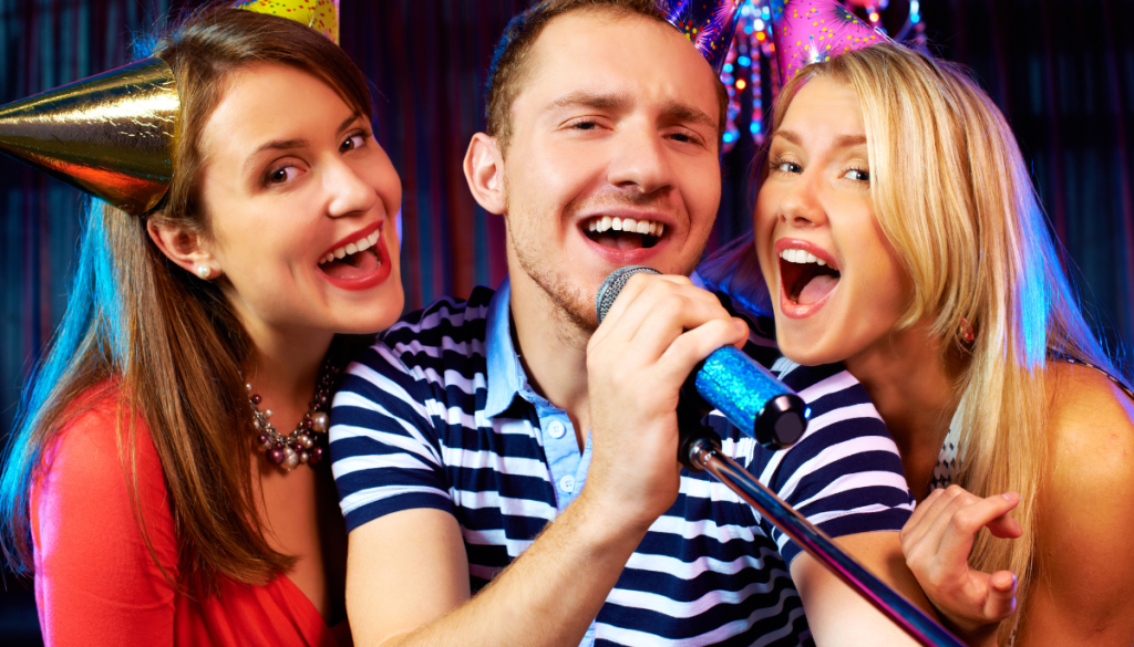 3 people gathered around a microphone at an insured Eurovision party.