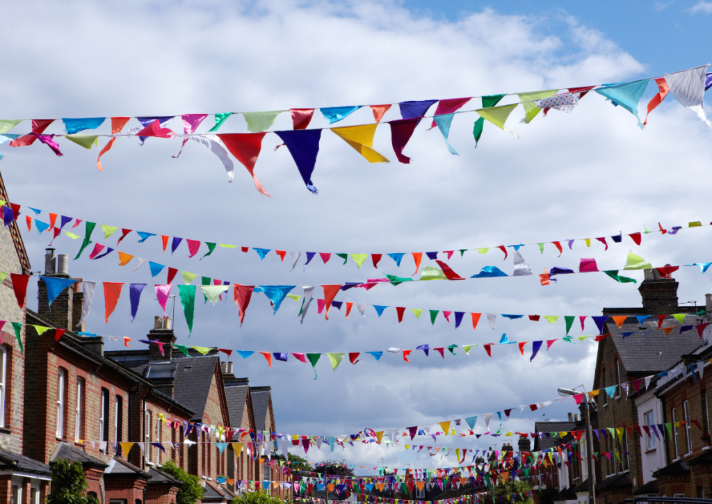 Street party bunting hung high all down the street as inspiration for summer event ideas.
