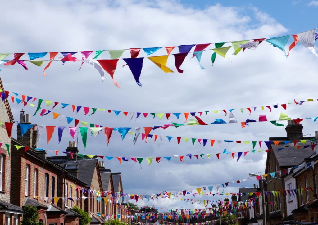 Street party bunting hung high all down the street as inspiration for summer event ideas.