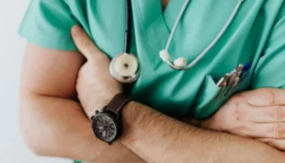 Crop doctor with stethoscope in hospital