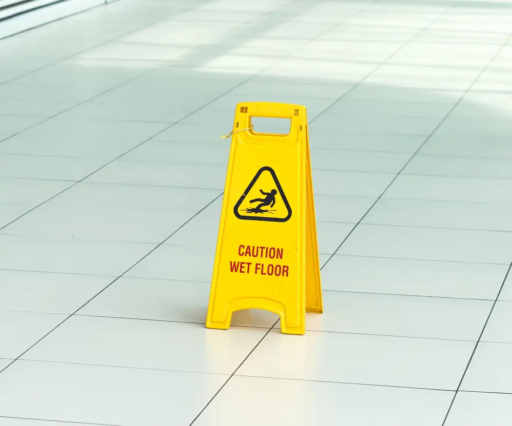 Yellow wet floor warning sign illustrating Event Public Liability Insurance