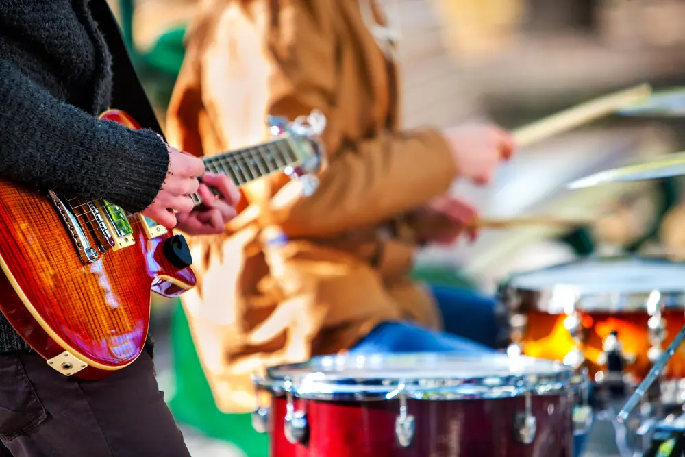 Guitarist and drummer performing live as part of a band