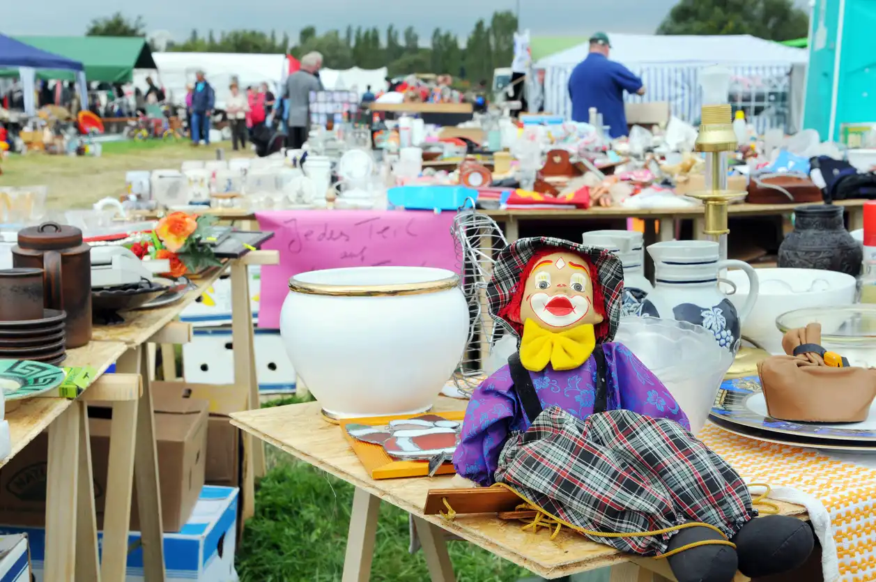 Stalls displaying second-hand goods at an outdoor car boot sale
